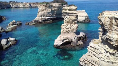 an aerial view of the ocean with rocky cliffs at Breezes B&B in Conca Specchiulla