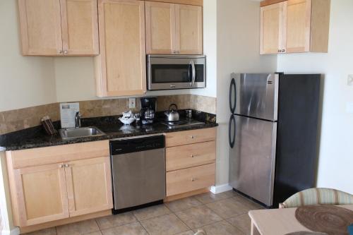 a kitchen with a refrigerator, stove, sink and microwave at Inn at the Shore in Seaside