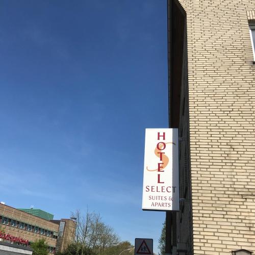 a sign on the side of a brick building at Hotel Select Suites & Aparts in Mönchengladbach