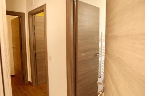 a closet with a wooden door in a room at Andolfi 24 Rooms in Pompei
