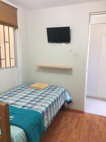 Ένα ή περισσότερα κρεβάτια σε δωμάτιο στο Hospedaje de los Reyes