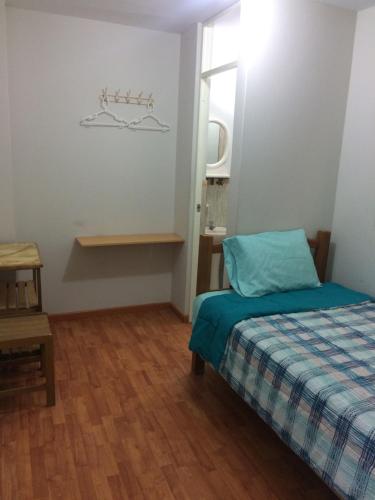 Ένα ή περισσότερα κρεβάτια σε δωμάτιο στο Hospedaje de los Reyes