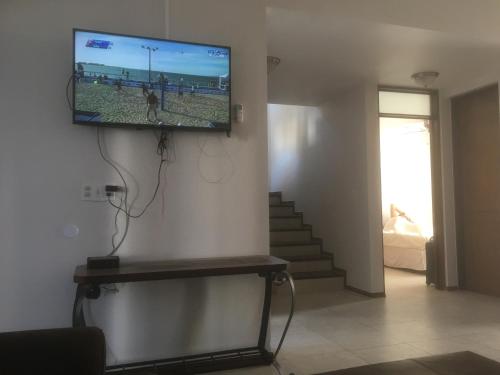 a flat screen tv hanging on a wall in a living room at Conjunto Ballena Townhouses in Puerto Peñasco