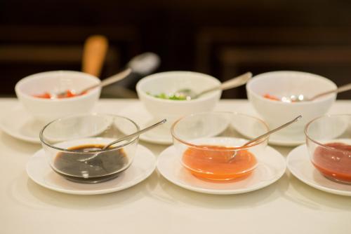 a table with four bowls of dipping sauces at Muong Thanh Hanoi Centre Hotel in Hanoi