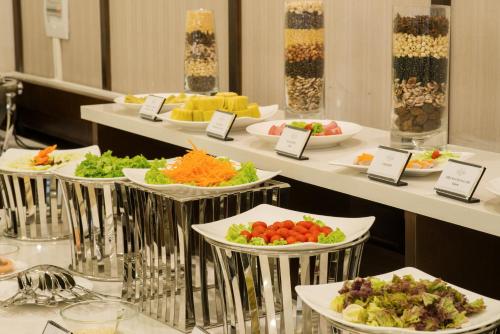 a buffet line with plates of food on display at Muong Thanh Hanoi Centre Hotel in Hanoi