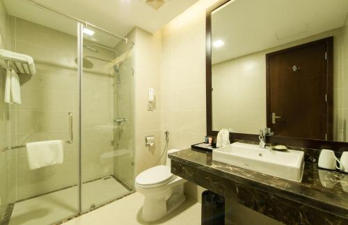 a bathroom with a sink and a toilet and a shower at Muong Thanh Hanoi Centre Hotel in Hanoi