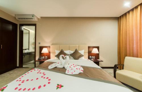 a bedroom with a bed with two stuffed animals on it at Muong Thanh Hanoi Centre Hotel in Hanoi