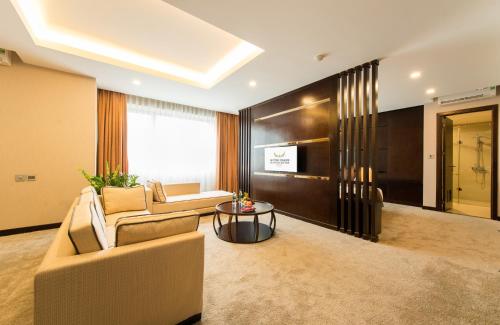 a living room with a couch and a table at Muong Thanh Hanoi Centre Hotel in Hanoi