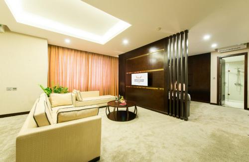 a living room with a couch and a table at Muong Thanh Hanoi Centre Hotel in Hanoi