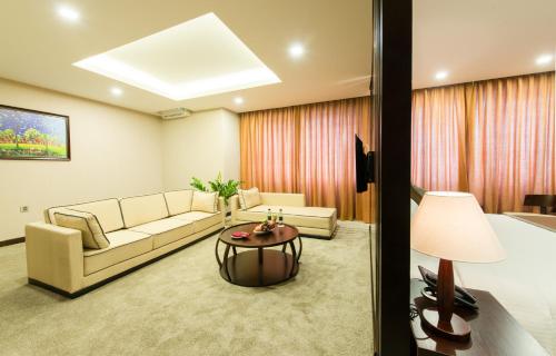 a living room with a couch and a table at Muong Thanh Hanoi Centre Hotel in Hanoi