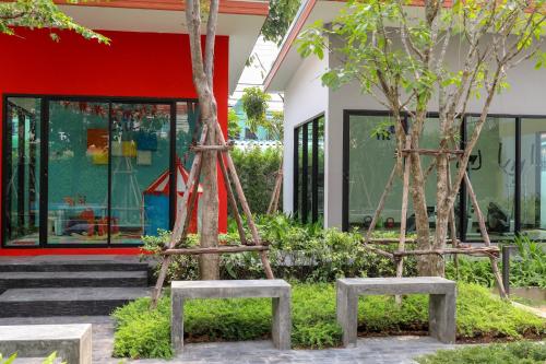 two trees in front of a building at Golden Sea Pattaya - SHA Extra Plus in Pattaya Central