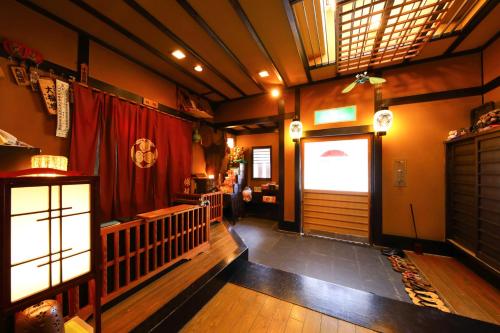 a room with a door and a red curtain at Onyado Takasago in Ureshino