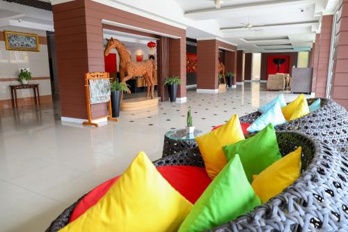 a lobby with a couch filled with colorful pillows at Golden Sea Pattaya - SHA Extra Plus in Pattaya Central