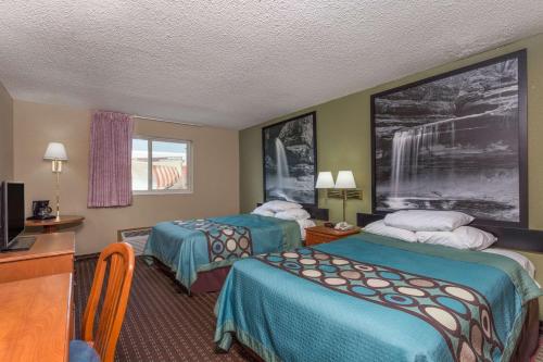 a hotel room with two beds and a desk at Super 8 by Wyndham Mendota in Mendota