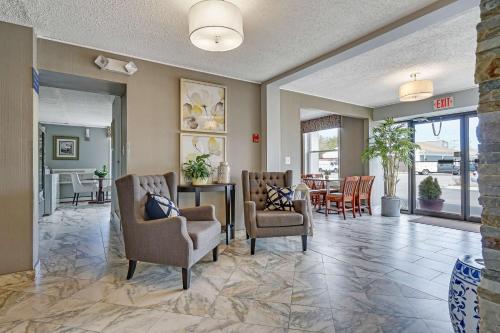 a lobby with chairs and a table and a dining room at Blue Creek Inn in Waretown