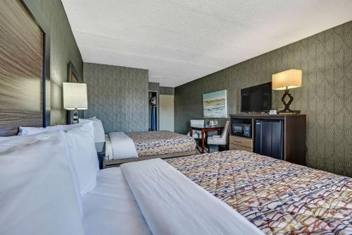 a hotel room with two beds and a desk at Blue Creek Inn in Waretown