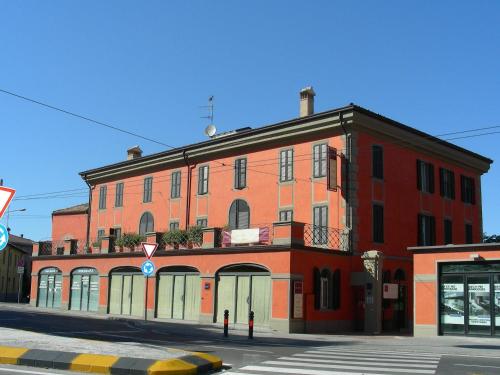 a building with a clock on the front of it at Residence Corte della Vittoria in Parma