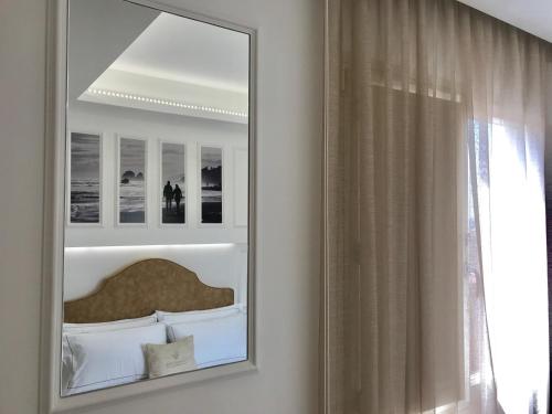 a mirror in a room with a bed and a window at Townhouse Tropea in Tropea