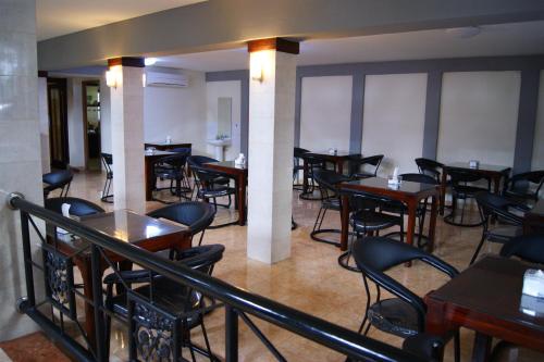 a restaurant with tables and chairs in a room at Hotel Grand Sumatera in Surabaya