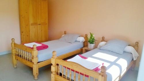two twin beds sitting next to each other in a room at Domaine de Surgy in Surgy