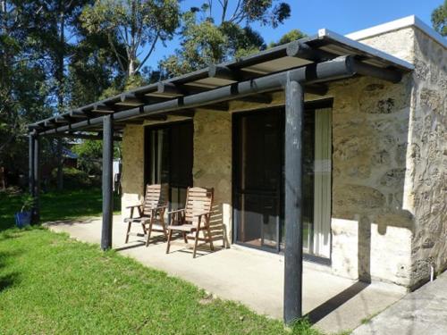 a pavilion with chairs and a table on a patio at Happy Dogs Cottage Margaret River in Margaret River Town