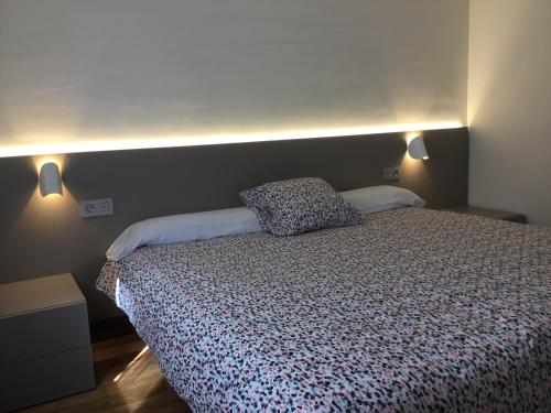 a bedroom with a bed with two pillows on it at Apartamentos Irati in Espinal-Auzperri