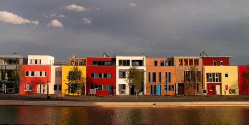 a row of buildings next to a body of water at Hotel Haus am Berg in Trier