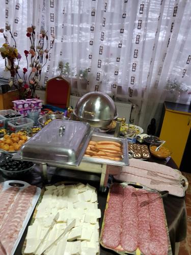 a table topped with different types of food at Pension Bran Ioana& SPA in Bran