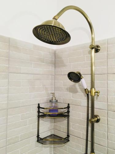 a shower with a shower head in a bathroom at Pensiunea Ambiance in Piatra Neamţ