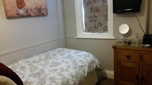 A bed or beds in a room at Streonshalh Bed & Breakfast 