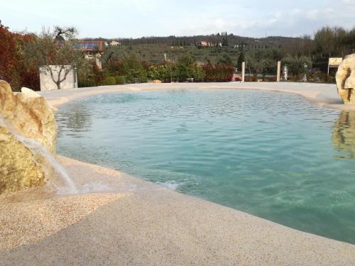 a swimming pool with water spewing out of it at La Zerla in Bardolino