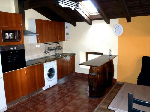 a kitchen with a washer and dryer in it at Eskolazaharra in Oronoz-Mugaire