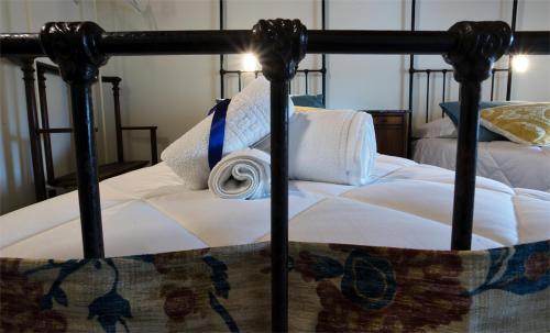 a bed with white sheets and a blue ribbon on it at Agriturismo Tenuta Casteldardo in Besenzone