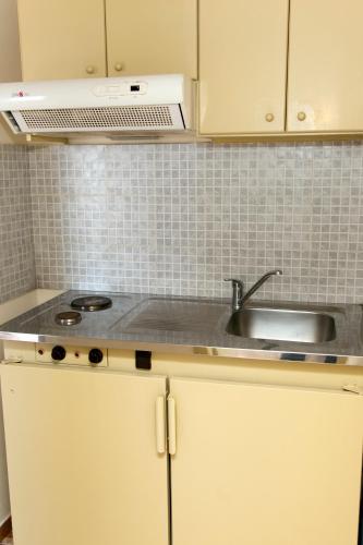 a kitchen with a sink and a counter top at Mithos Apartments in Agia Marina Nea Kydonias