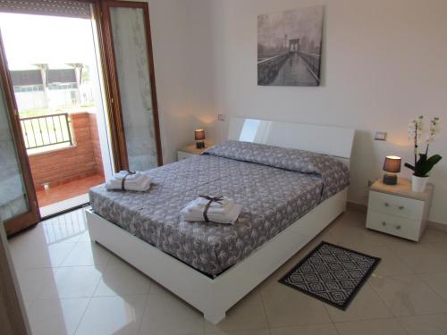 a bedroom with a bed with two towels on it at Siviero Apartments in Scardovari