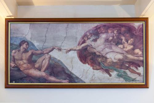 a painting of two men on a wall at Casa Leone Hotel in Chania Town