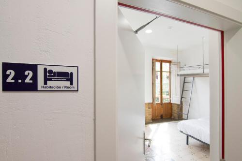 a door leading into a room with a bedroom at ECO Hostel in Granada