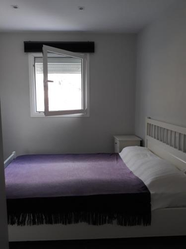 a bedroom with a bed and a window at modern holiday apartment with private pool in Adeje