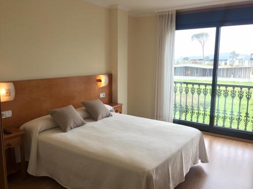 Postel nebo postele na pokoji v ubytování Hostal Santa Baia