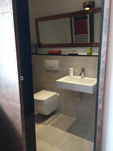 a bathroom with a toilet and a sink at Hotel Aleo in Bochum