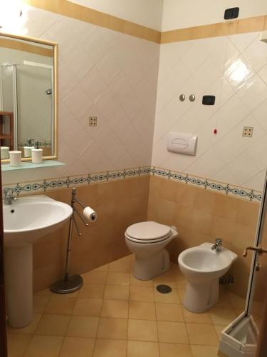 a bathroom with a toilet and a sink at Villa delle Sirene in Ascea