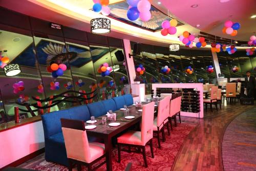 a dining room with a table and chairs and balloons at Ana Clarks Inn, Panchkula in Panchkula