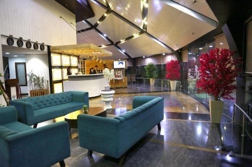 a lobby with two blue couches and a table at Ana Clarks Inn, Panchkula in Panchkula