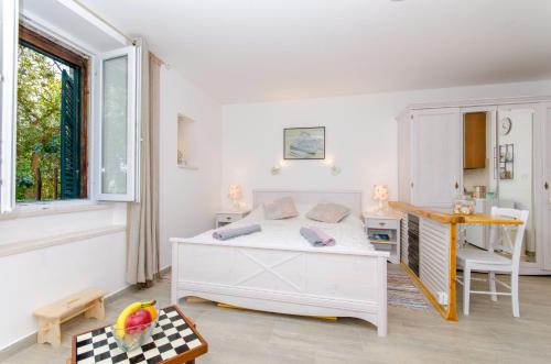 a bedroom with a white bed and a desk at Apartment Hello Love in Split