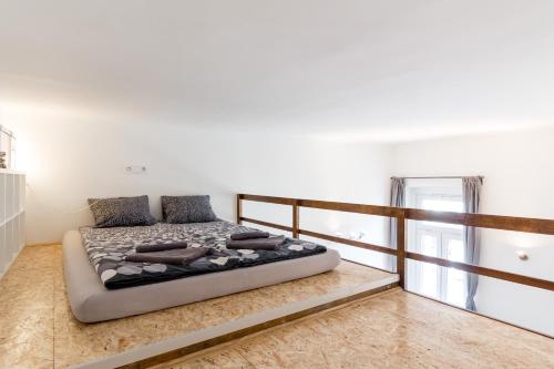 a bedroom with a bed in the middle of a room at Flexible SelfCheckIns 13 & 14 - Le Petit & Le Grand Zagreb - Centre - New - Apartments Repinc in Zagreb