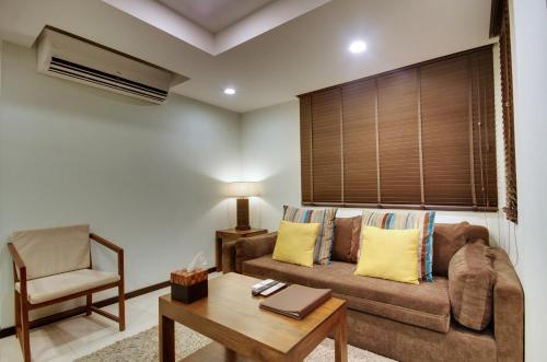 a living room with a couch and a chair at The Somerset Hotel in Male City