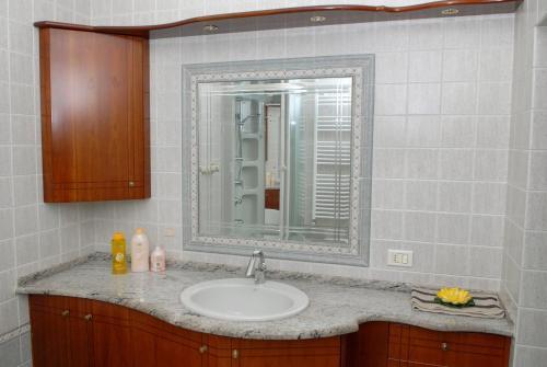 a bathroom with a sink and a mirror at Mare And City House in Manfredonia