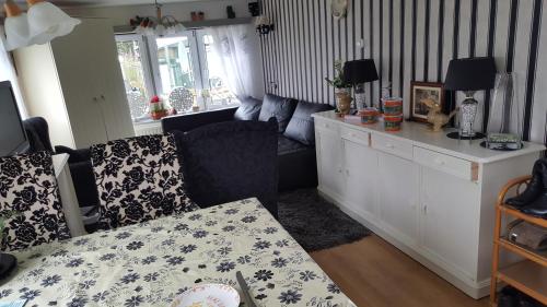 a living room with a couch and a table at Ferienhhaus-Mobilheim freies WLAN in Sirjansland