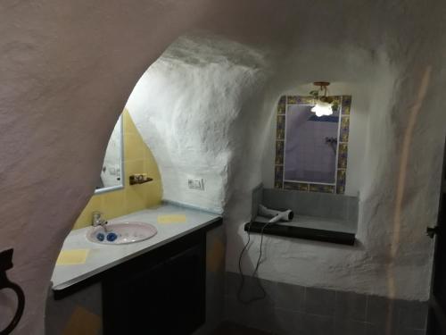 a bathroom with a sink and a mirror at Cueva Peralta in Cortes de Baza