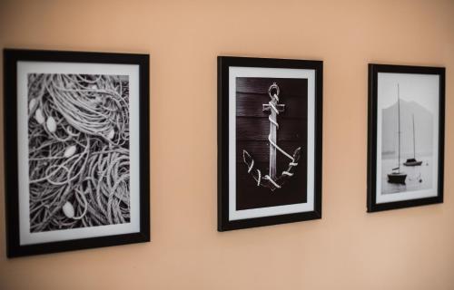 a group of three framed pictures on a wall at Apartament Zwycięstwa in Koszalin